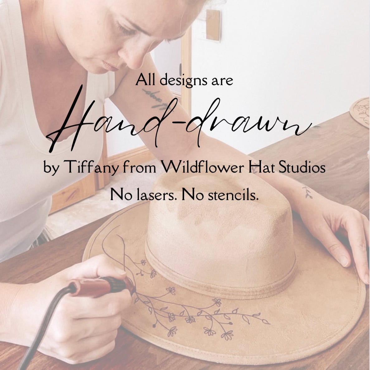 artist drawing on hats