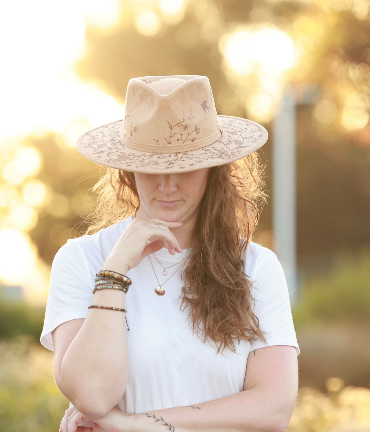 boho woman with light tan fedora