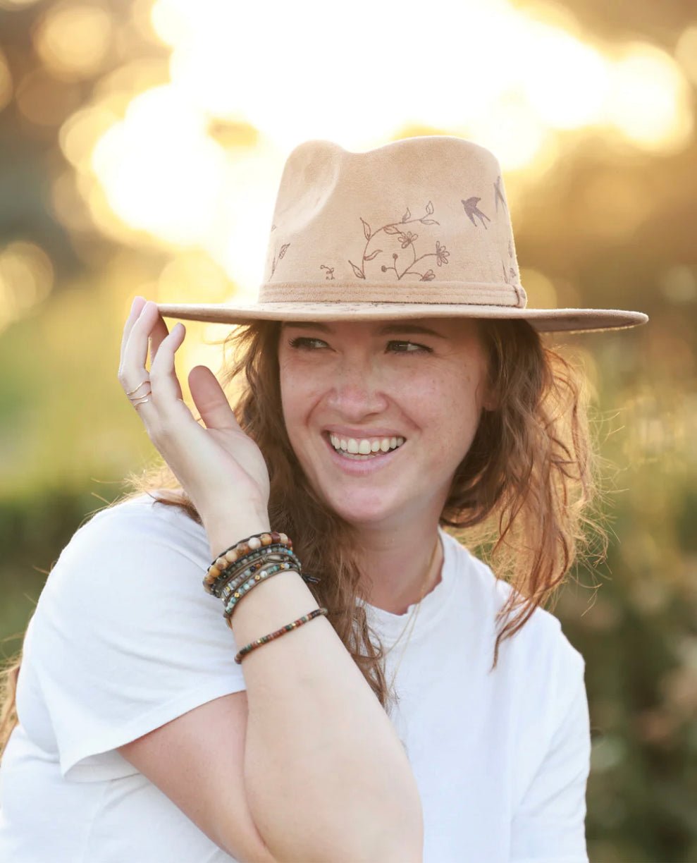 boho woman with light tan fedora