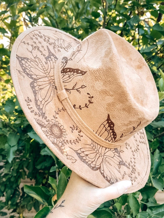 Boho hat with large floral and butterfly design on brim and crown shown in light tan