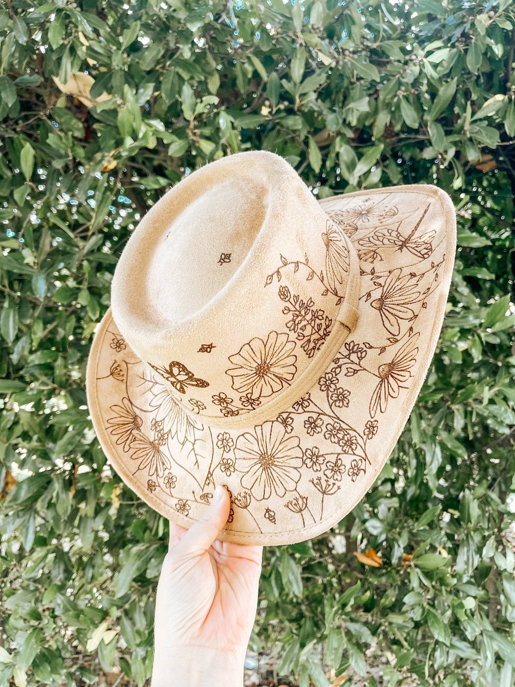 Cowgirl hat with hand-drawn wildflowers, butterflies, bees, and dragonflies around brim