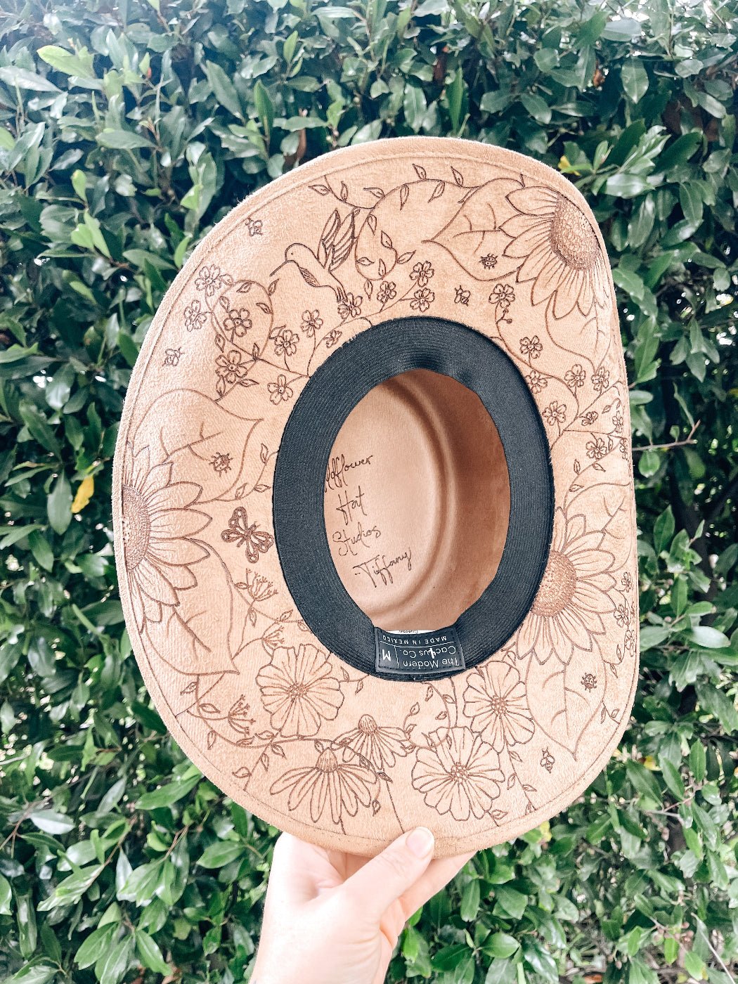 Cowgirl hat with hand-drawn wildflowers, butterflies, bees, and dragonflies around brim