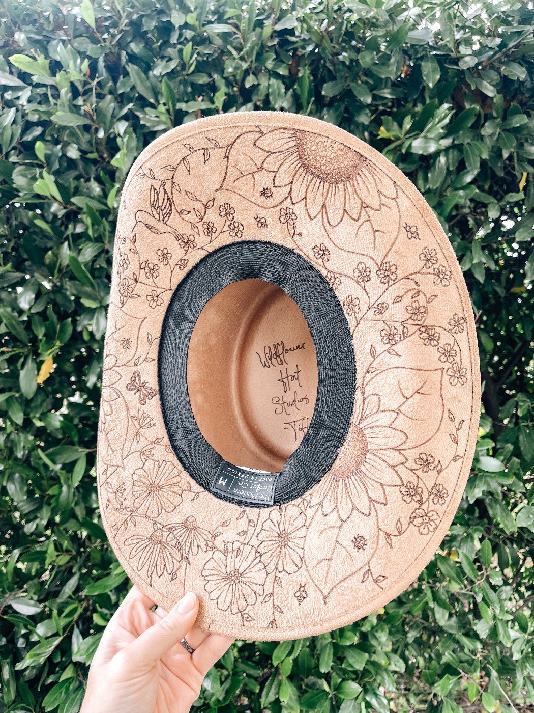 Cowgirl hat with hand-drawn wildflowers, butterflies, bees, and dragonflies around brim