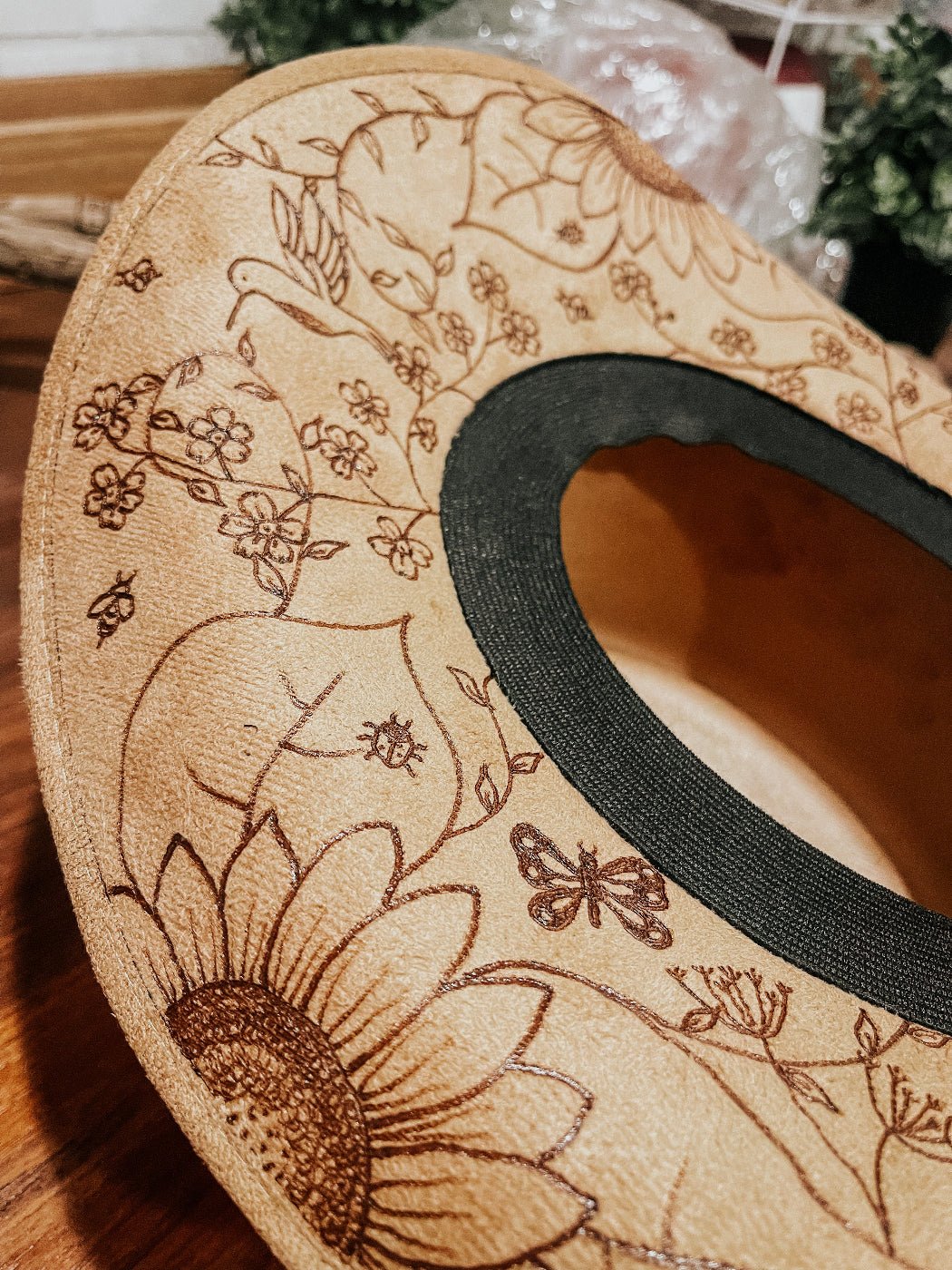 Cowgirl hat with hand-drawn wildflowers, butterflies, bees, and dragonflies around brim. Hummingbird, sunflower, and forget me nots detail.