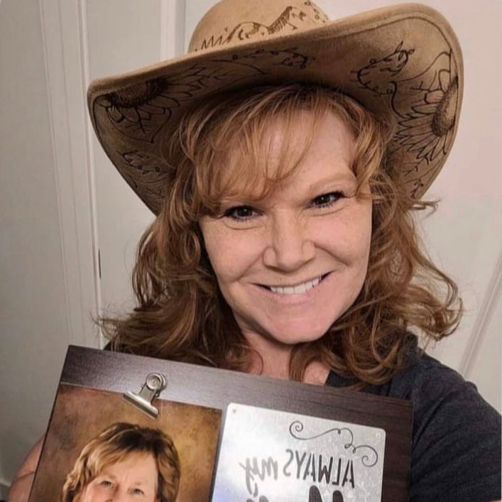 Customer photo of woman wearing a custom sunflower cowboy hat with mountains and whispy fines