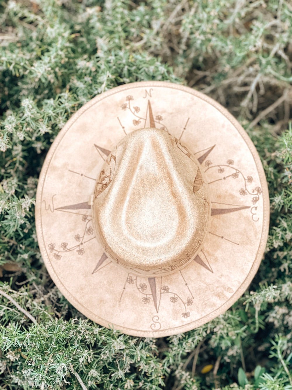 Rustic light tan fedora hat with mountains, compass and wildflowers