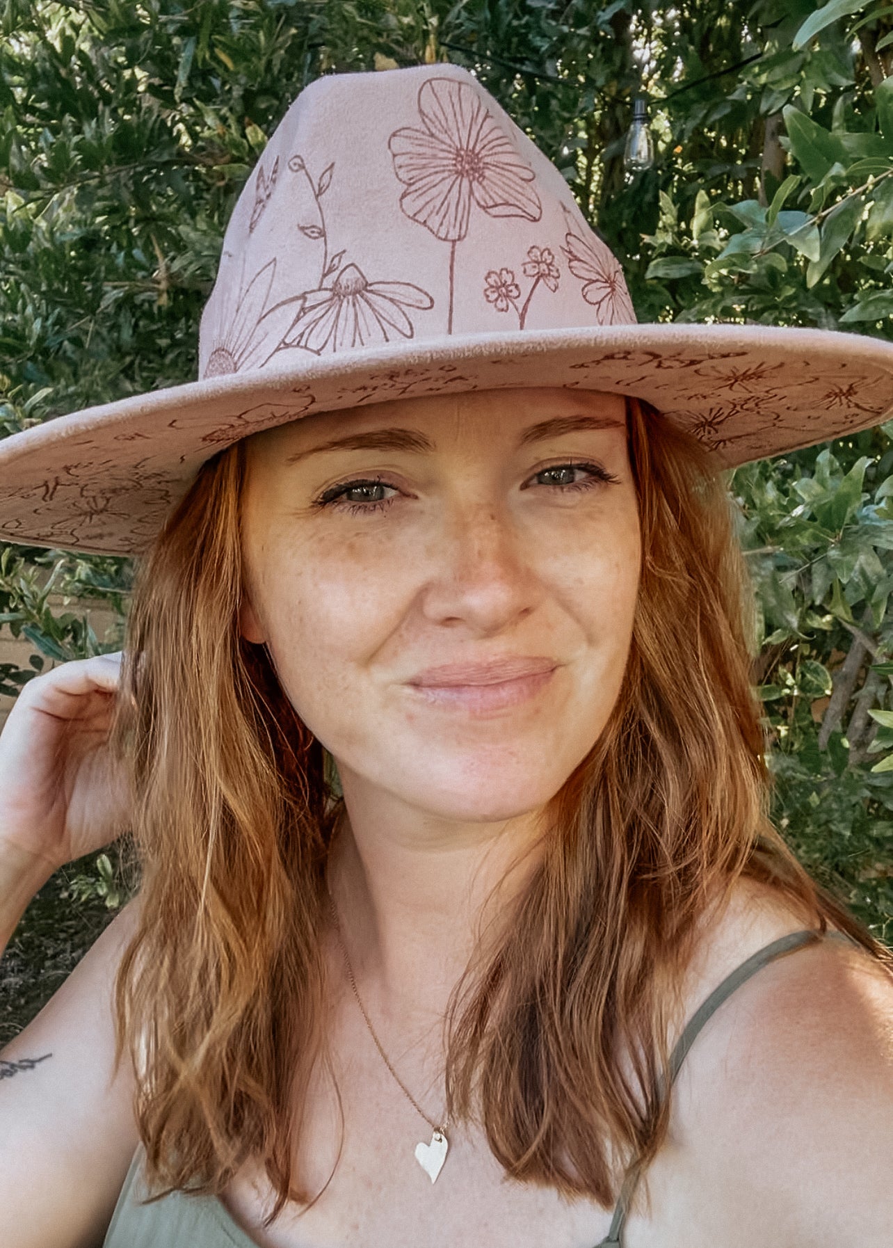 Blush pink wide-brimmed hat with floral patterns