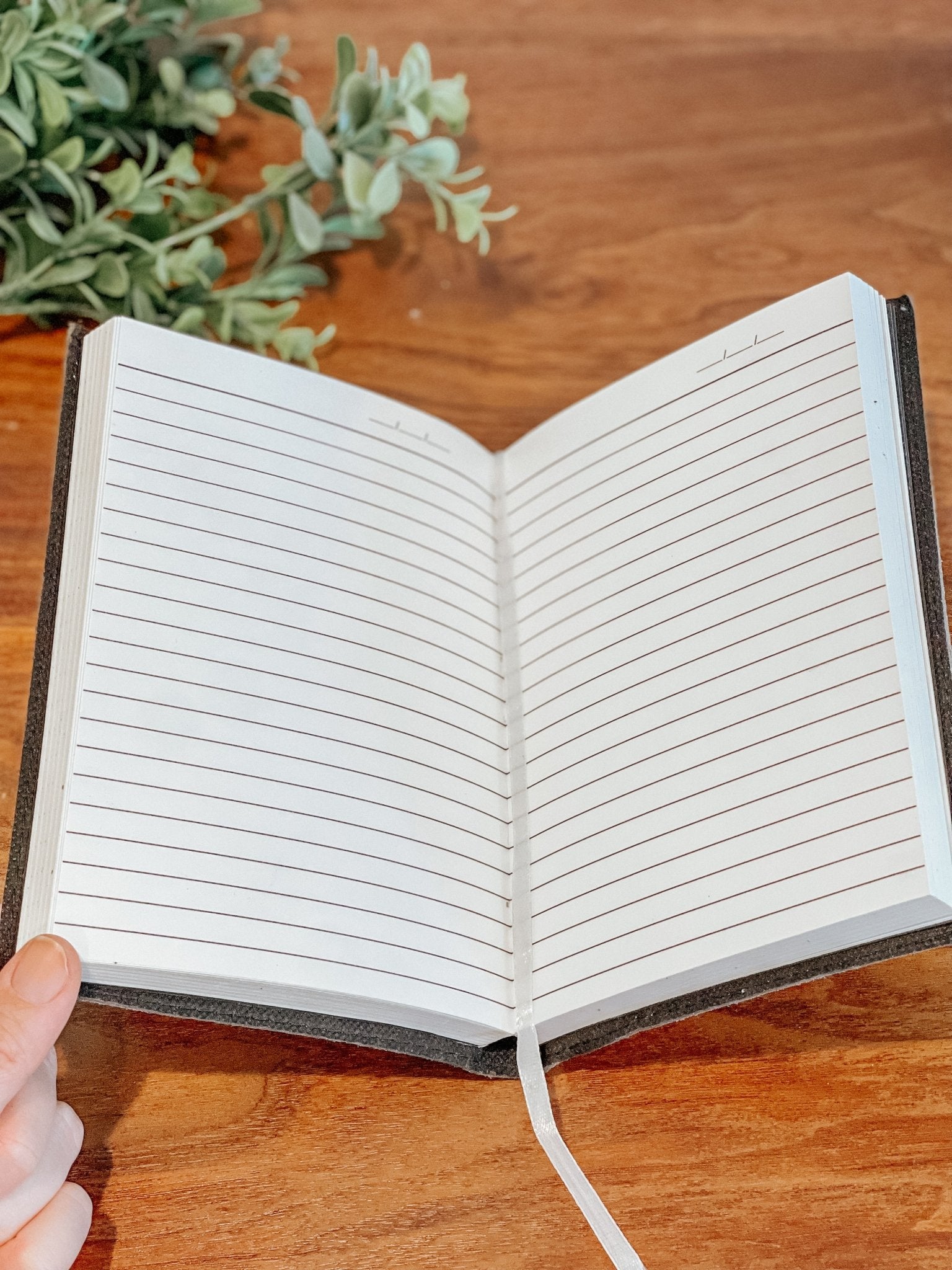 Lined pages inside gray sunflower journal with elastic closure and ribbon bookmark