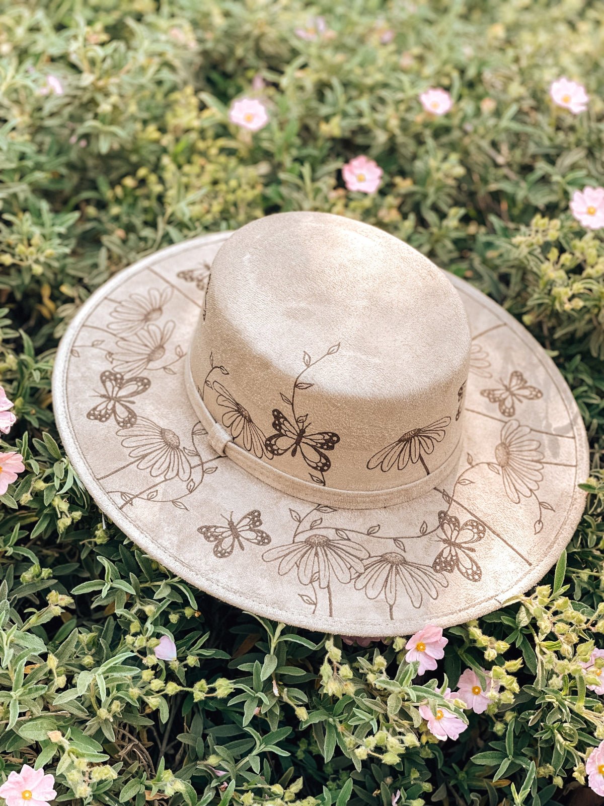 kids light taupe boater hat with monarch butterflies, daisies, and whimsical vines on the brim