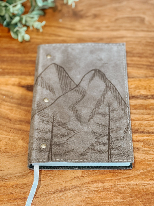 Gray faux suede journal with hand-burned mountain scene, spruce trees, and flying birds