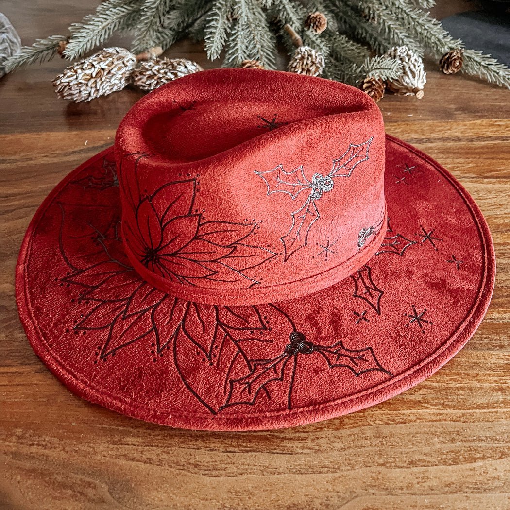 Red fedora with hand-drawn poinsettia, sparkle illustrations, and winter vines