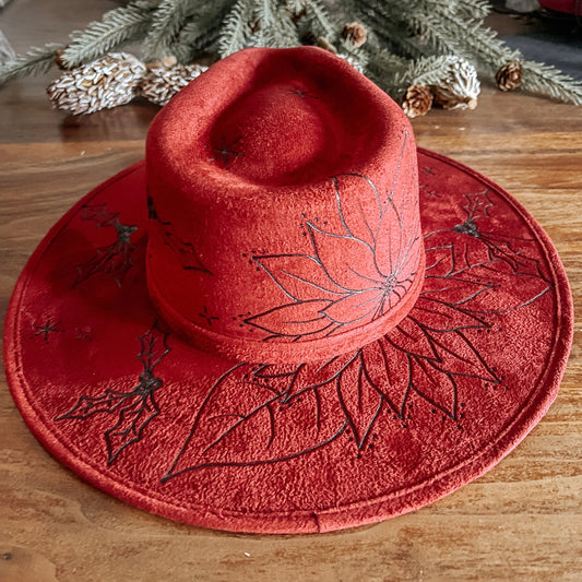 Red fedora with hand-drawn poinsettia, sparkle illustrations, and winter vines