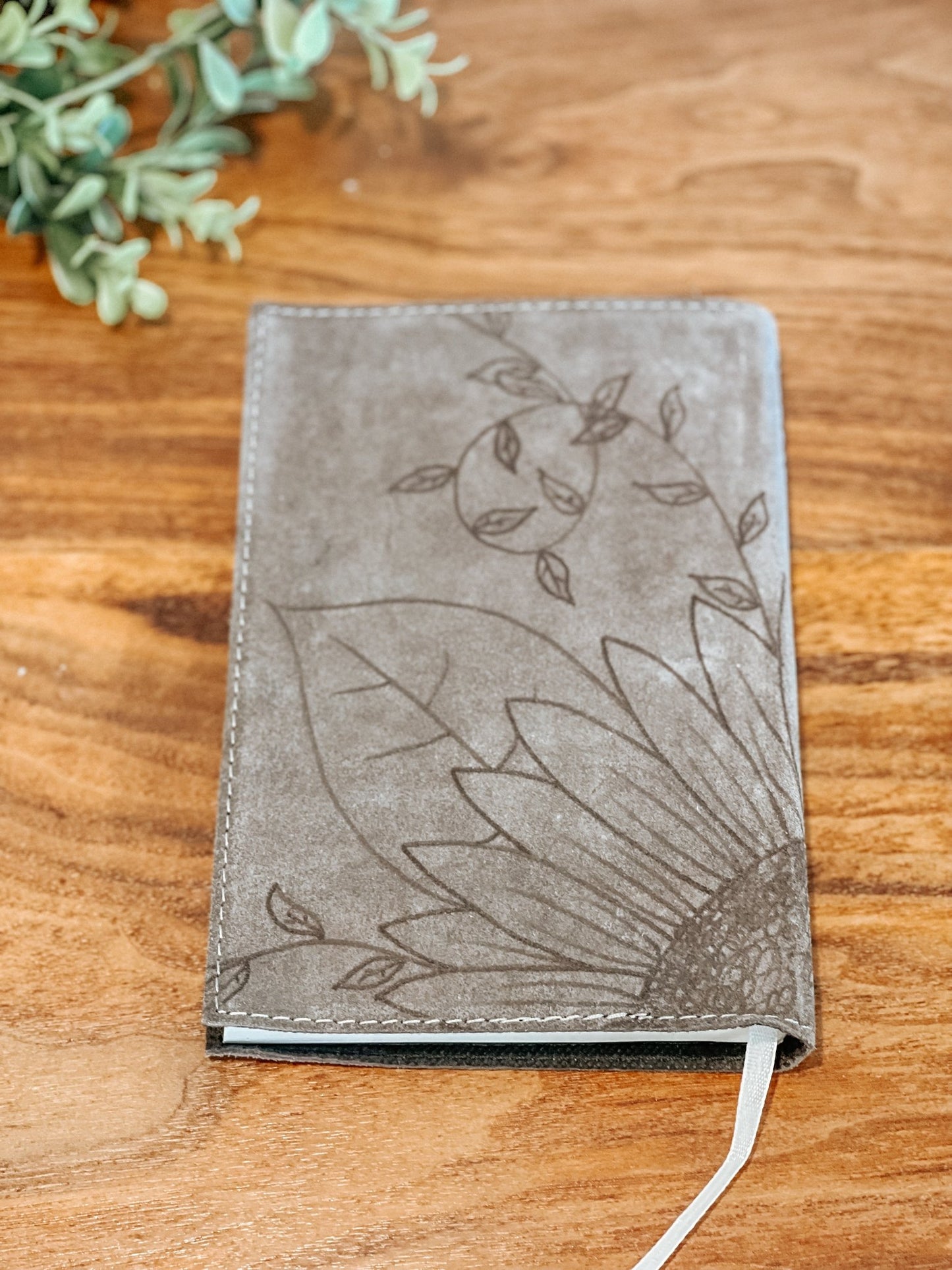 Gray faux suede journal with hand-burned sunflower design on the back cover