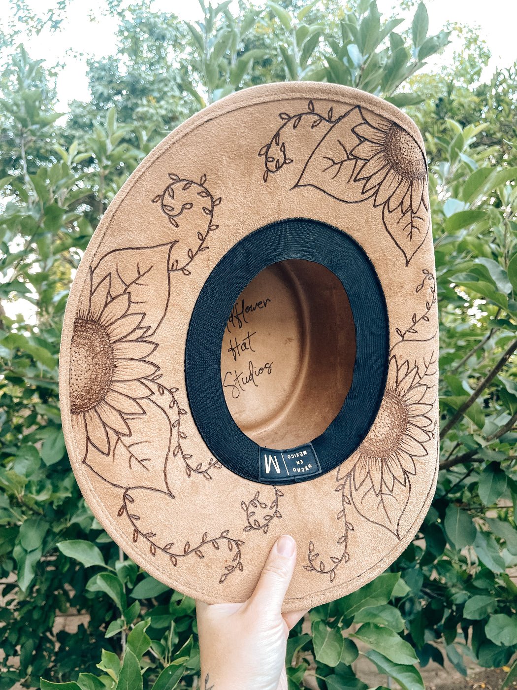 Western floral hat with bold sunflower artwork in boho style