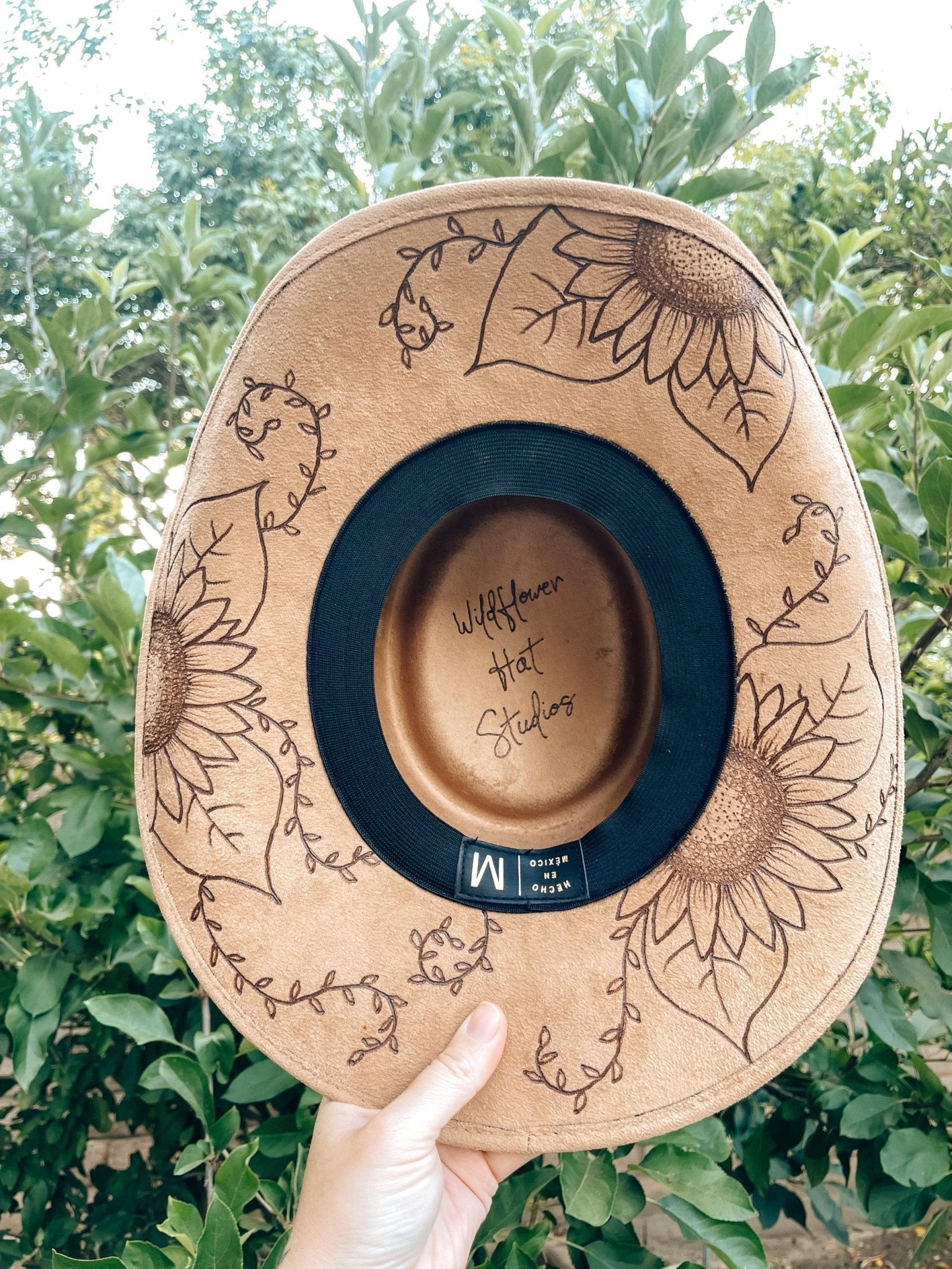 Western floral hat with bold sunflower artwork in boho style