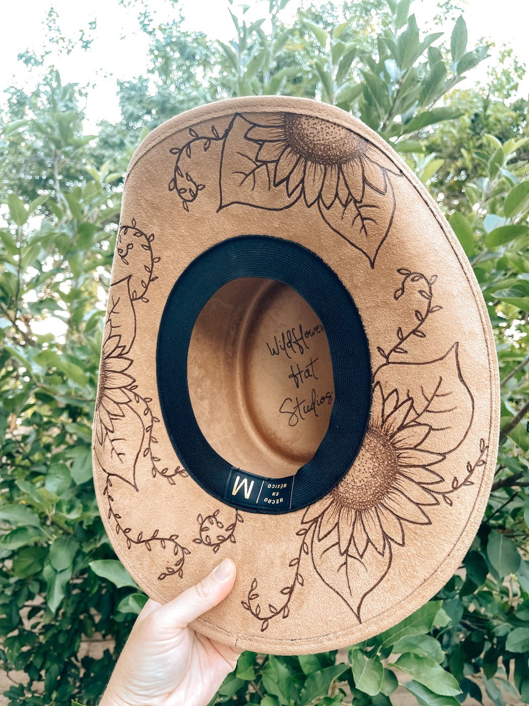 Western floral hat with bold sunflower artwork in boho style