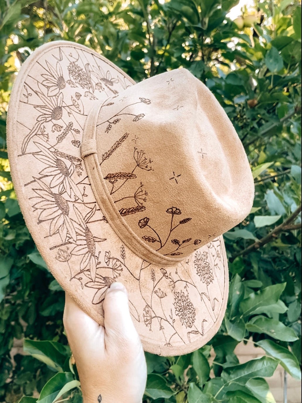 Maximalist fedora covered in hand-drawn wildflowers, inspired by California superbloom shown in light tan