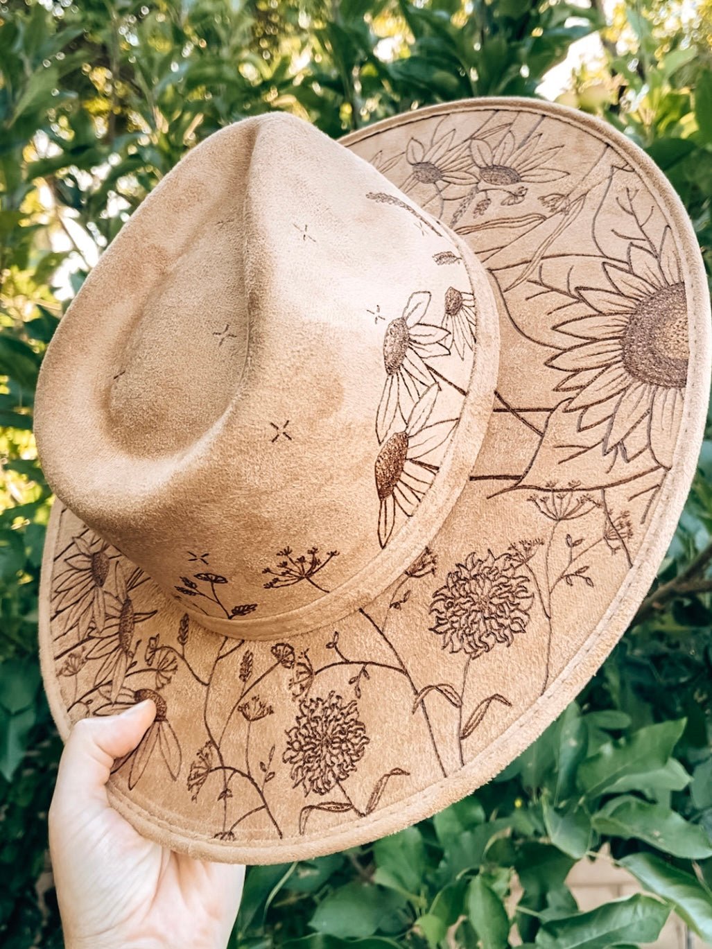 Maximalist fedora covered in hand-drawn wildflowers, inspired by California superbloom shown in light tan