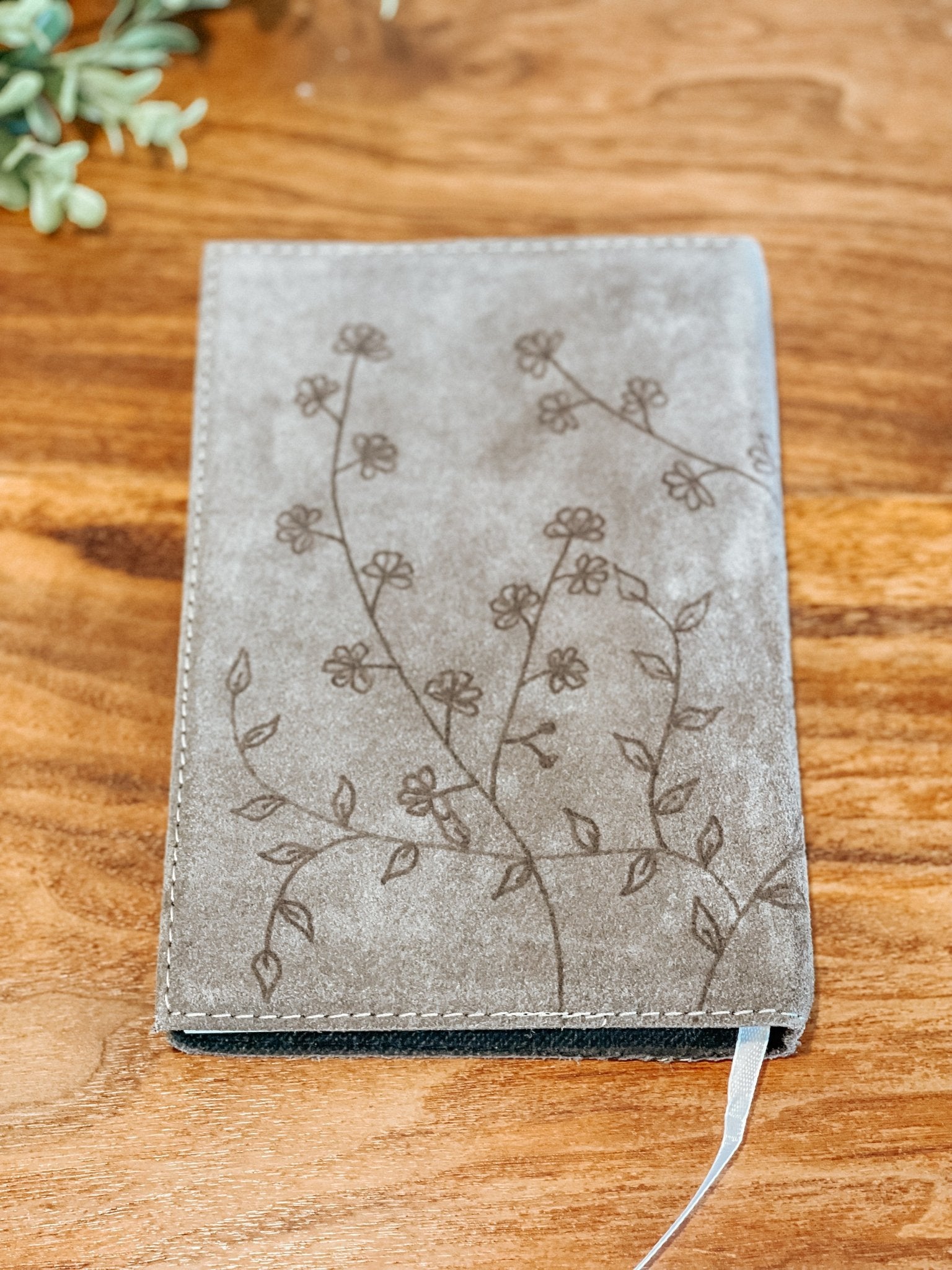 Gray faux suede journal with hand-burned wildflower illustration on the back cover