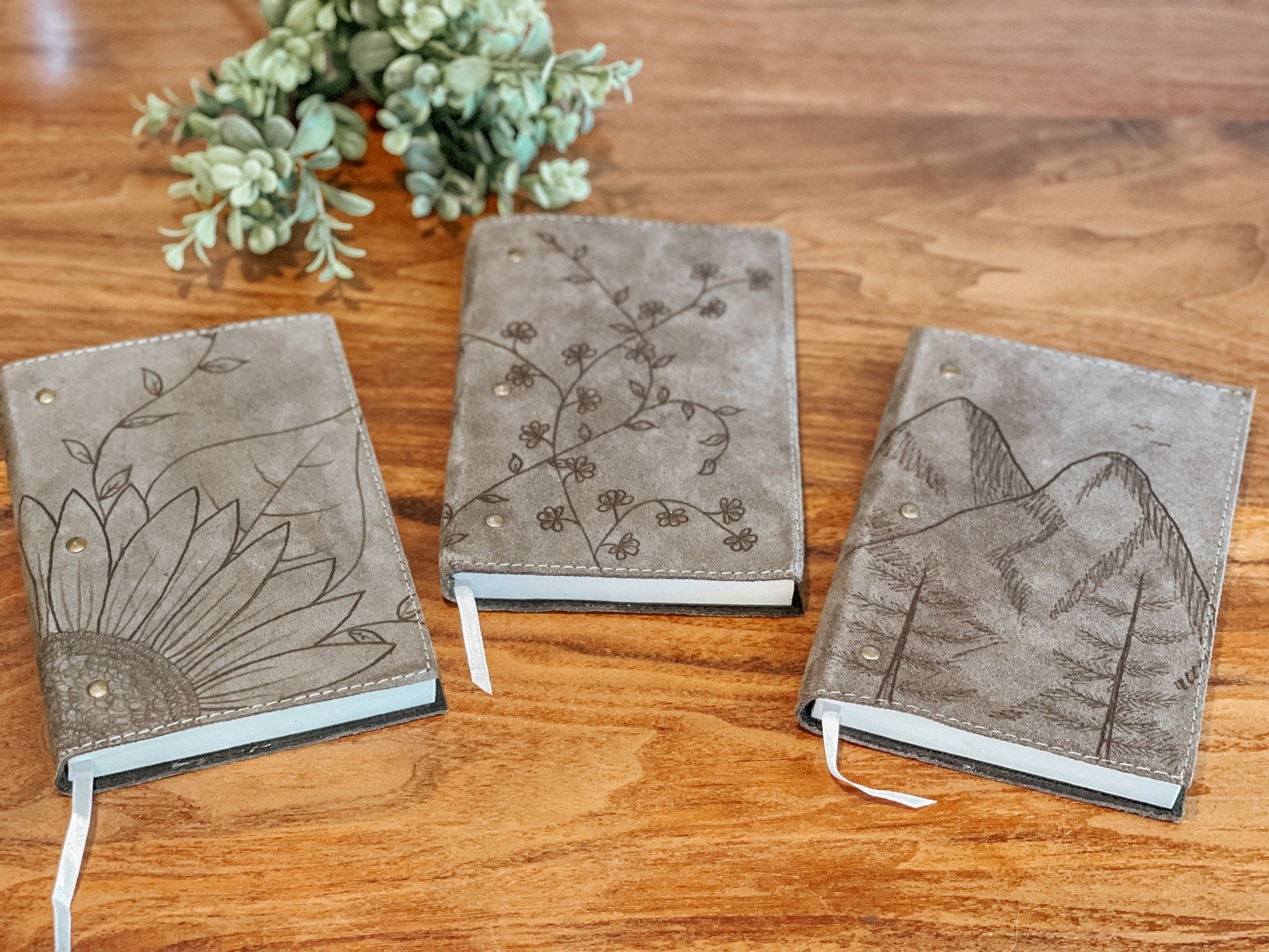 wildflower hat studios' journal collection featuring sunflower, wildflower, and mountain designs.