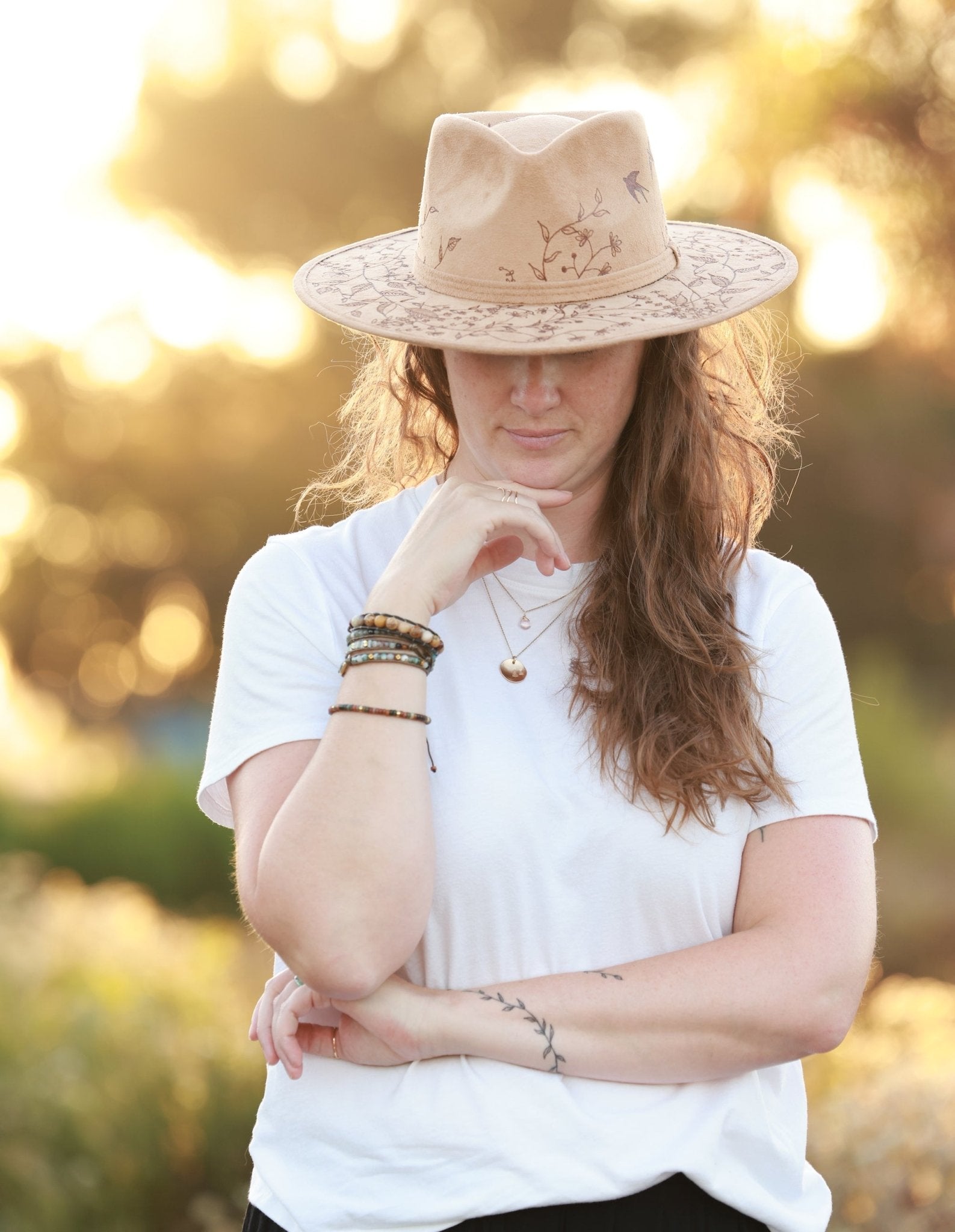 boho woman wearing light tan fedora